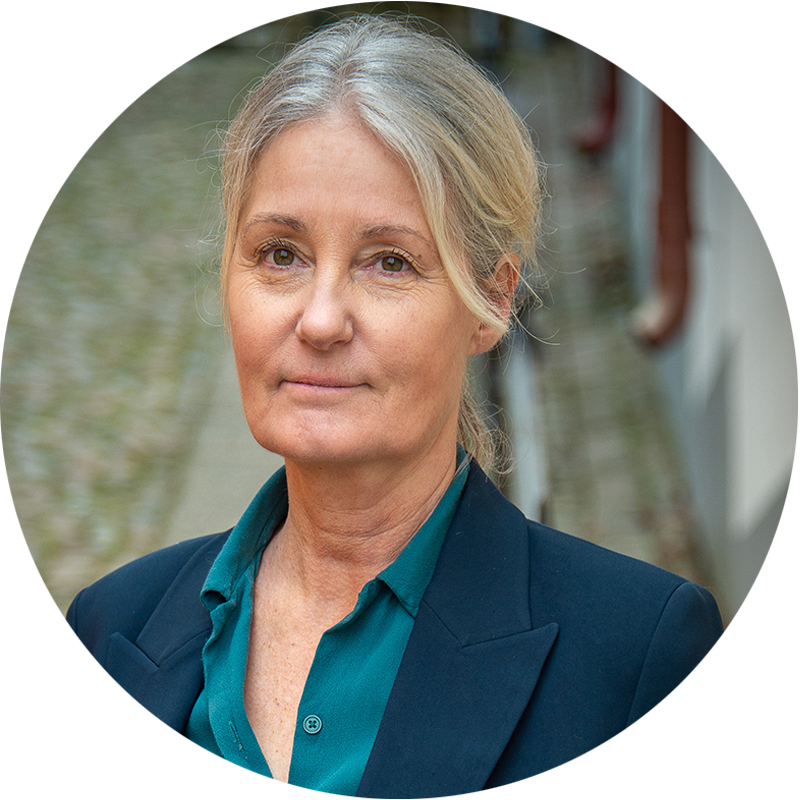 a woman with grey hair wearing a blue shirt and a blue shirt